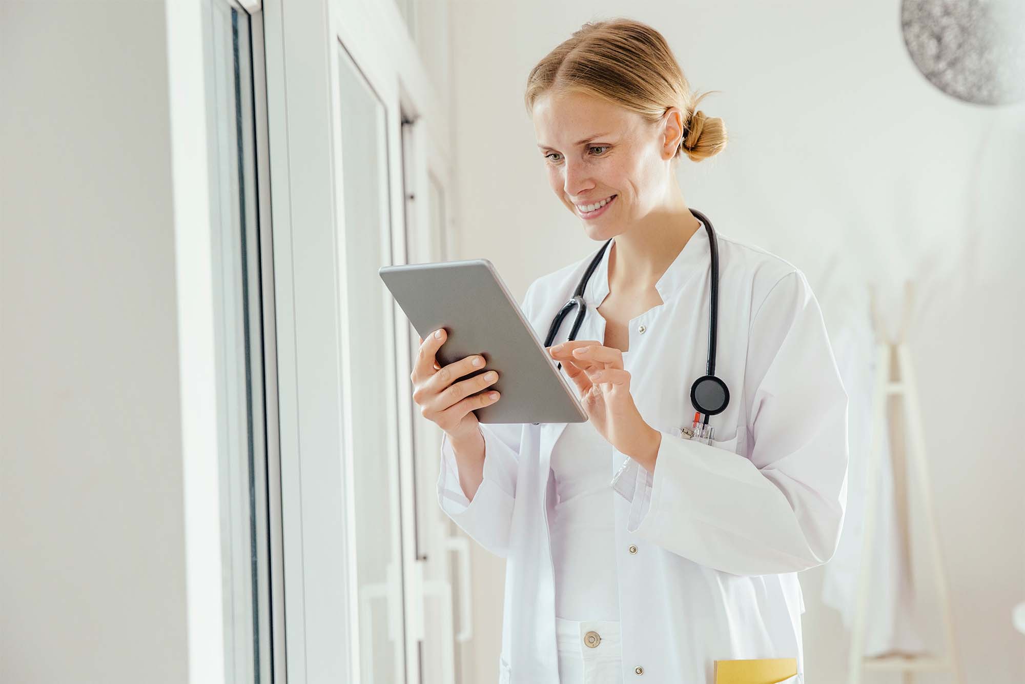 Nurse utilizing electronic forms to capture patient records.