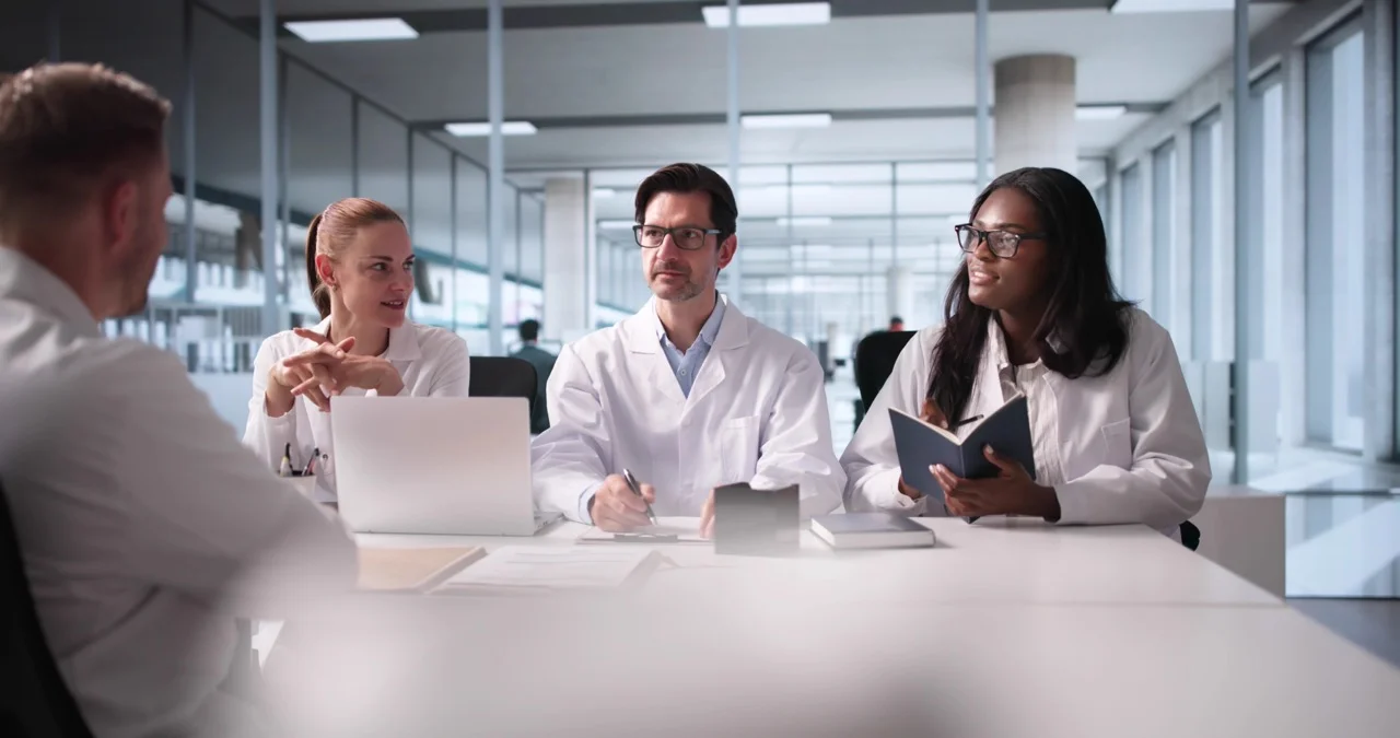 Healthcare,Recruitment,Specialists,Meeting,With,Prospective,Hospital,Doctors,For,Hire Healthcare administrator reviewing dbtech downtime solution tier pricing options for 3 to 5 workstation Tier 1 deployment at a critical access hospital