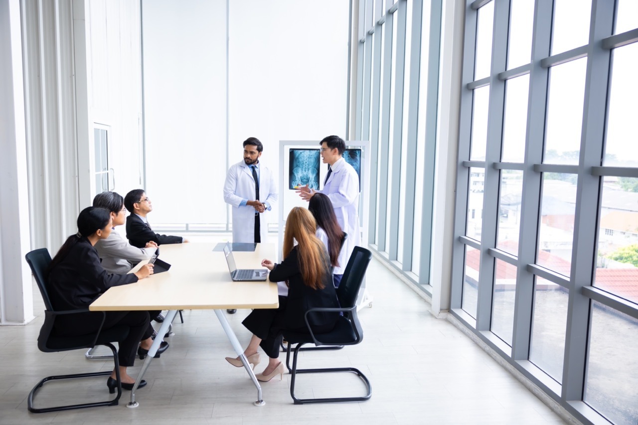 Healthcare IT director reviewing EHR outage business continuity plan components including downtime workstation activation protocol and post-recovery data reconciliation steps