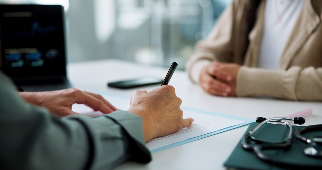 hospital registration staff manually processing paper intake forms