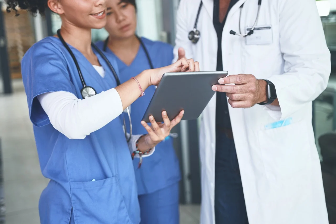 Healthcare administrative staff retrieving patient consent documents from an organized electronic eFolders repository