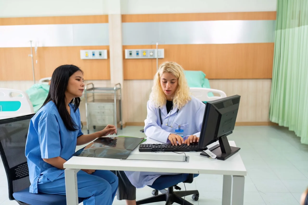 Downtime program coordinator reviewing activation timing and recovery data after an EHR outage