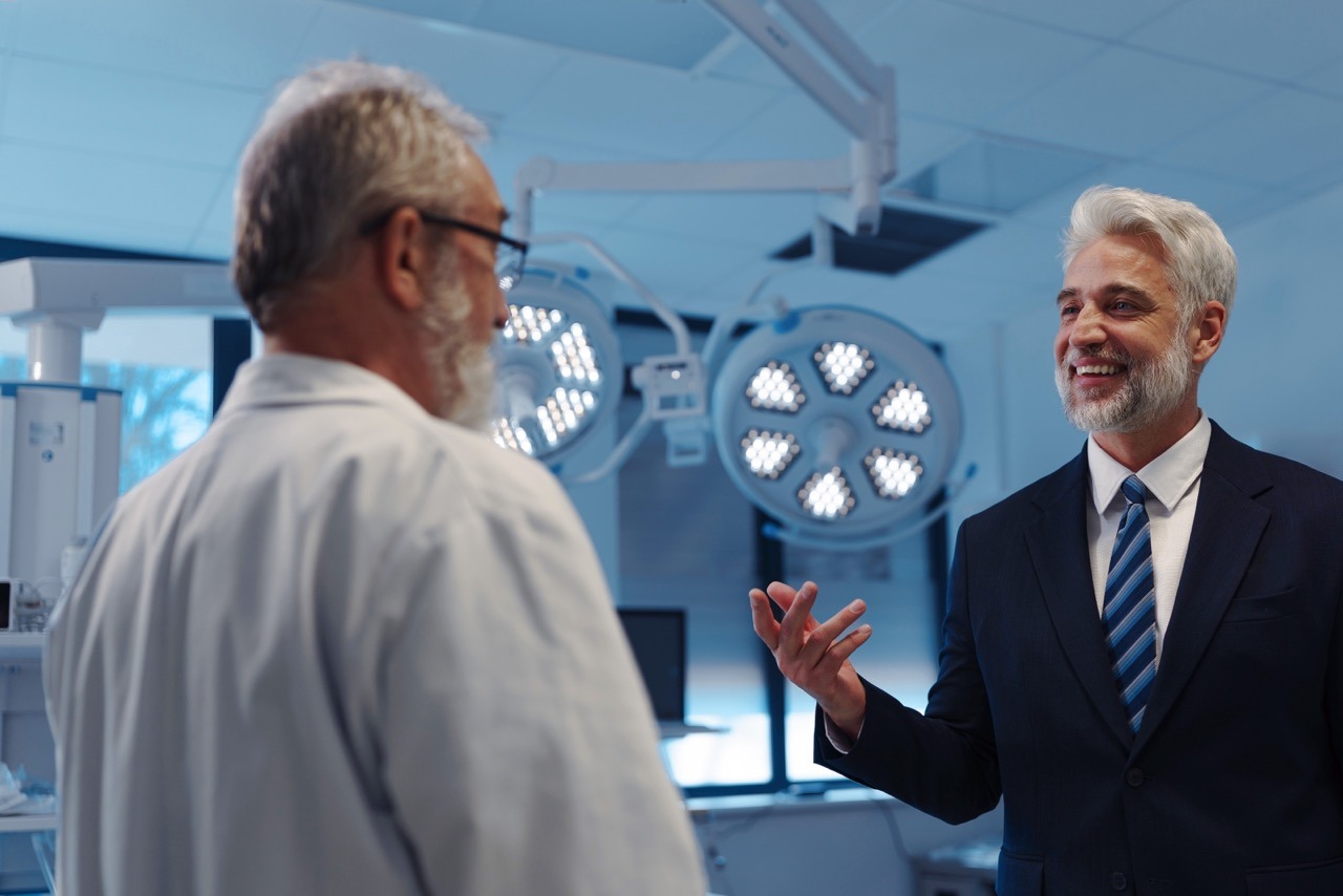 Hospital executive discussing EHR vendor downtime responsibility with a physician