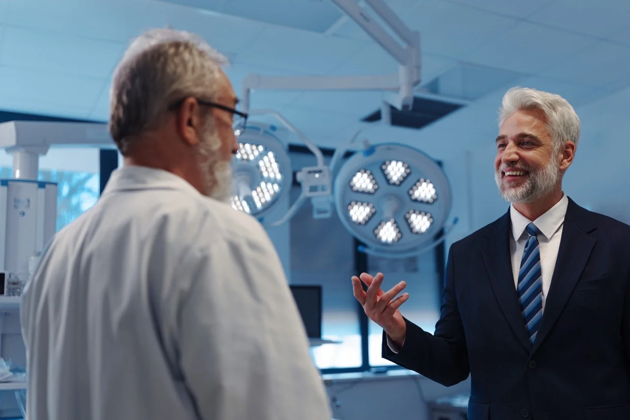 Hospital executive discussing EHR vendor downtime responsibility with a physician